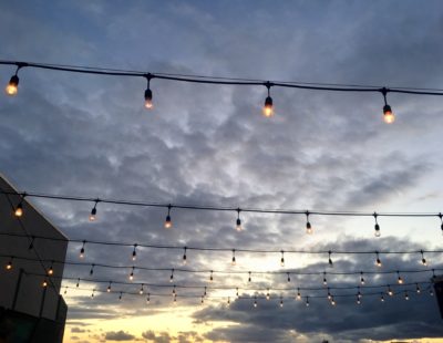 Outdoor string lights against the sky