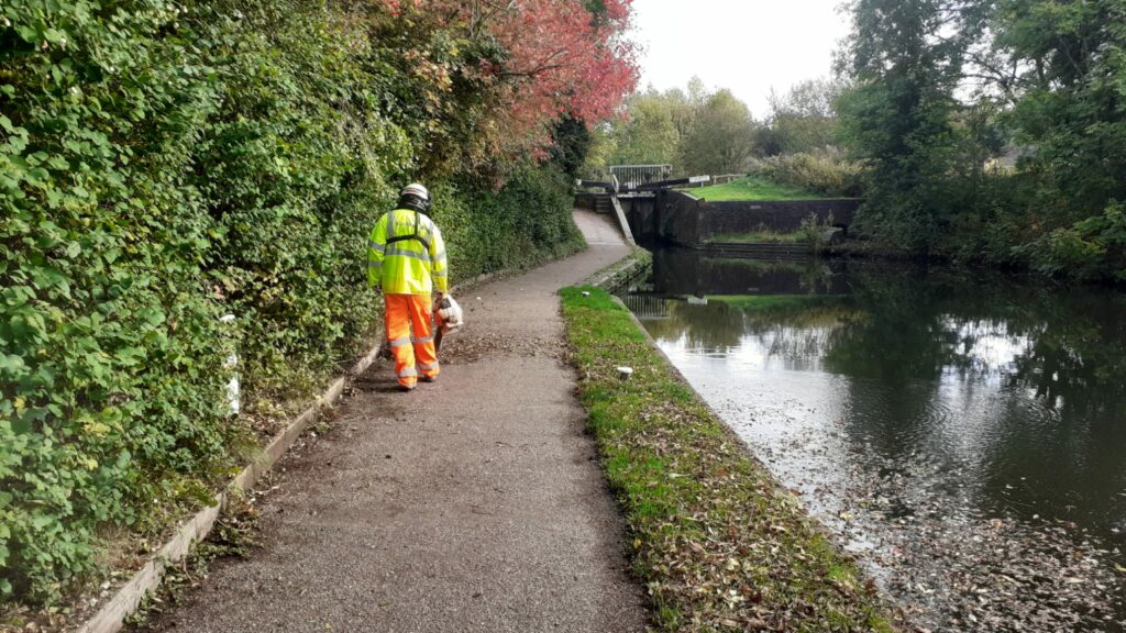 Solareye team clearing canal towpath with leaf blower