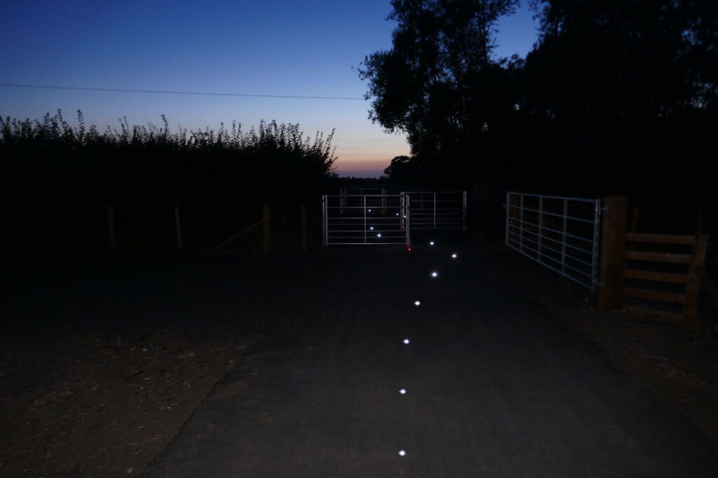 solar ground lights on path with gate
